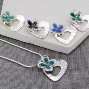 Personalised enamel daisy and hammered heart pendants