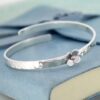 Personalised baby bangle with daisy
