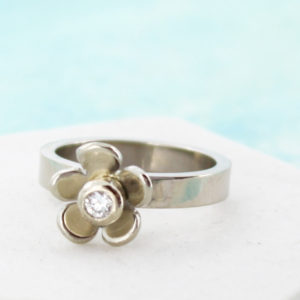 Daisy and diamond engagement ring in white gold