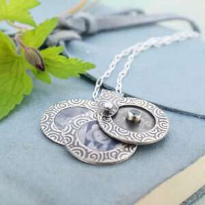 handmade textured silver photo locket with aquamarine