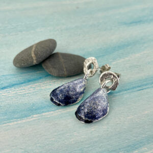 These silver and enamel mussel shell earrings are handmade in Cornwall.