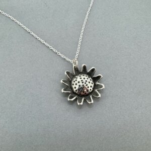 Silver sunflower pendant on 16" chain